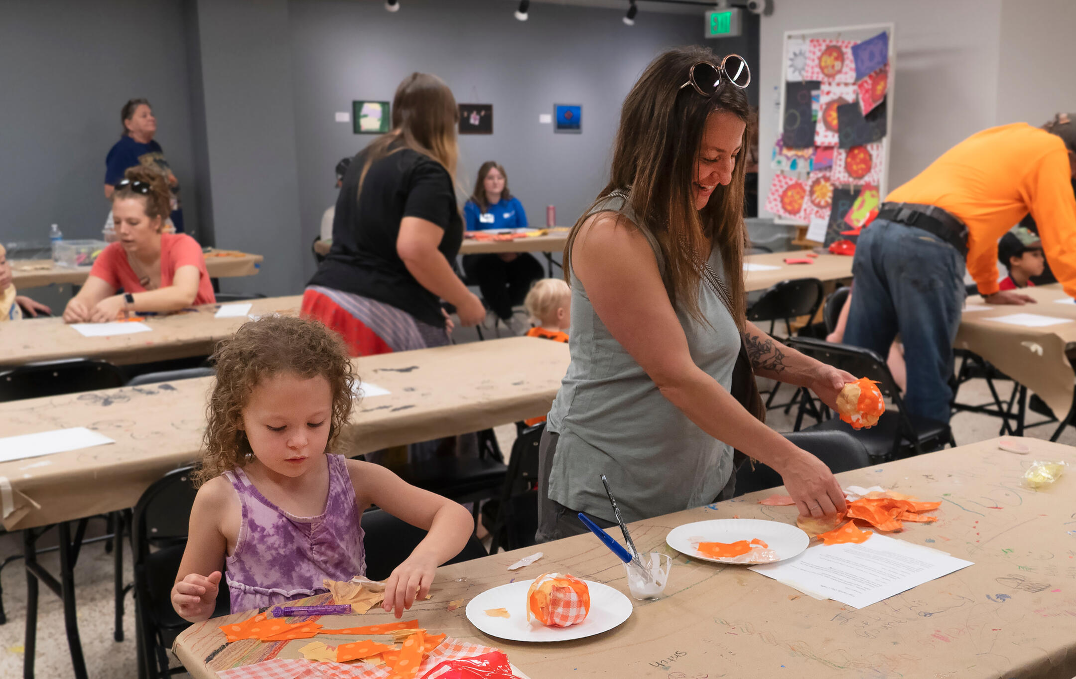 Fall Family Day at RAM Family smiling while creating a craft inside the Fort Smith Regional Art Museum